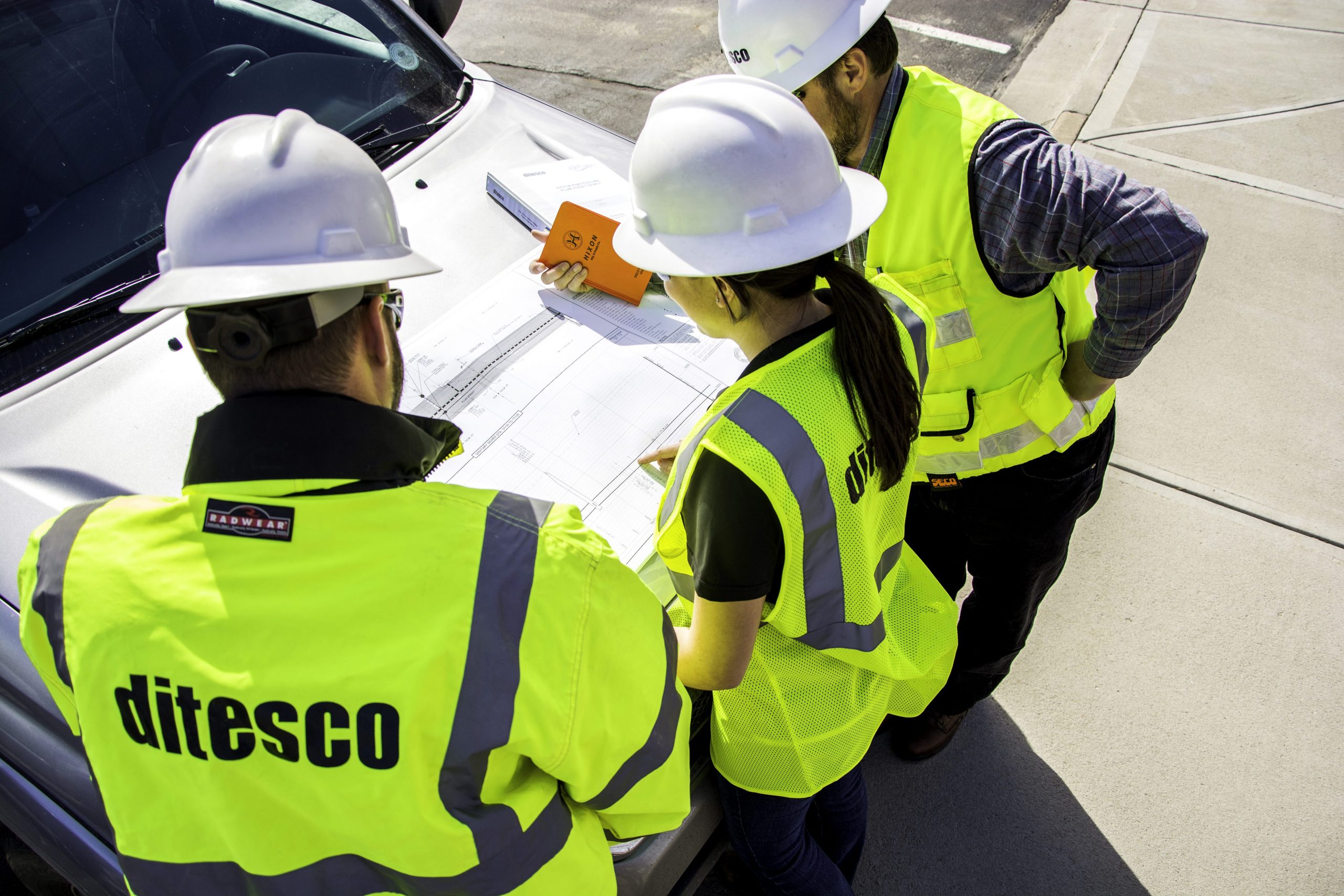 Image of ditesco construction workers inspecting blue prints