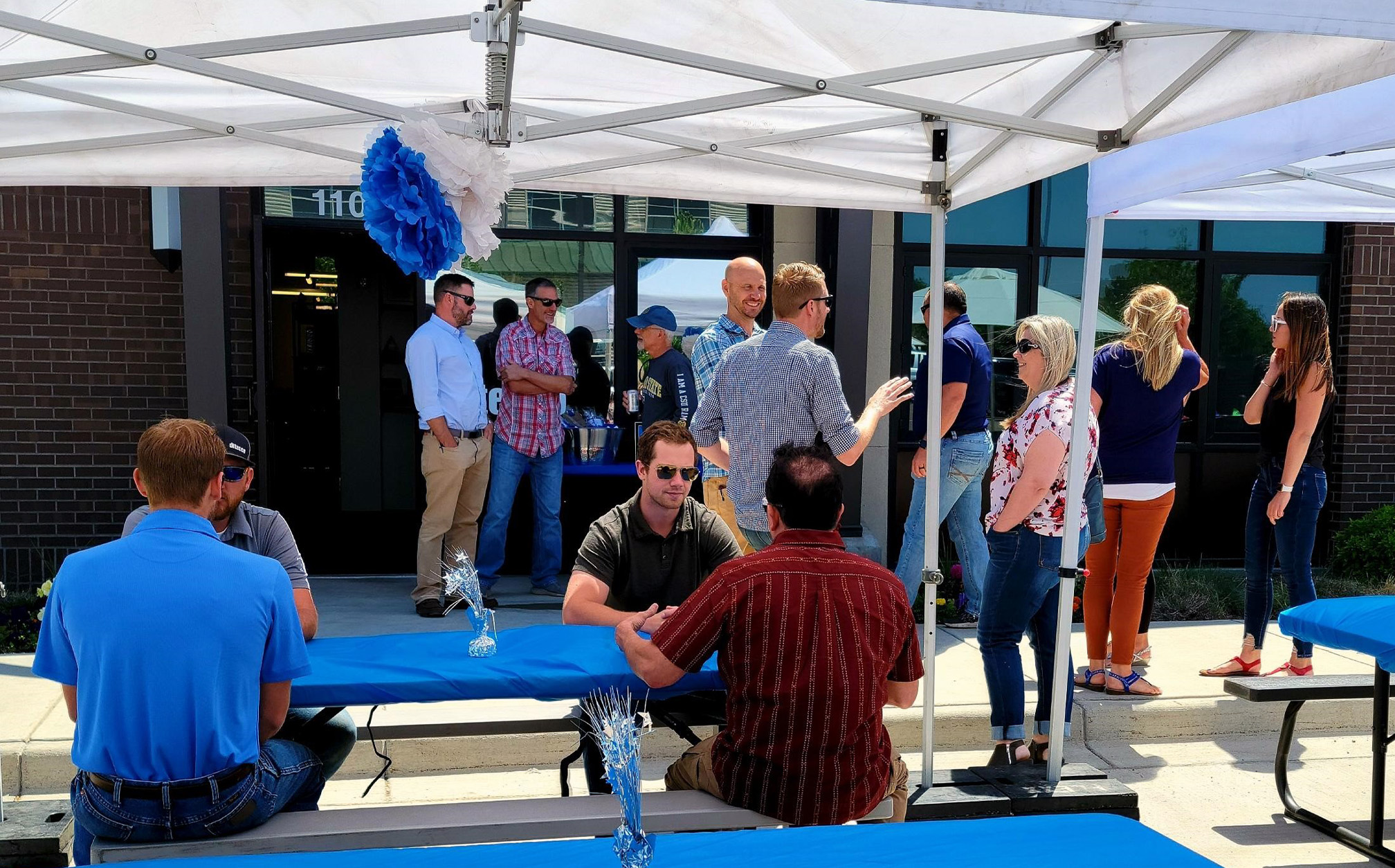 Group of employees outside celebrating company anniversary.