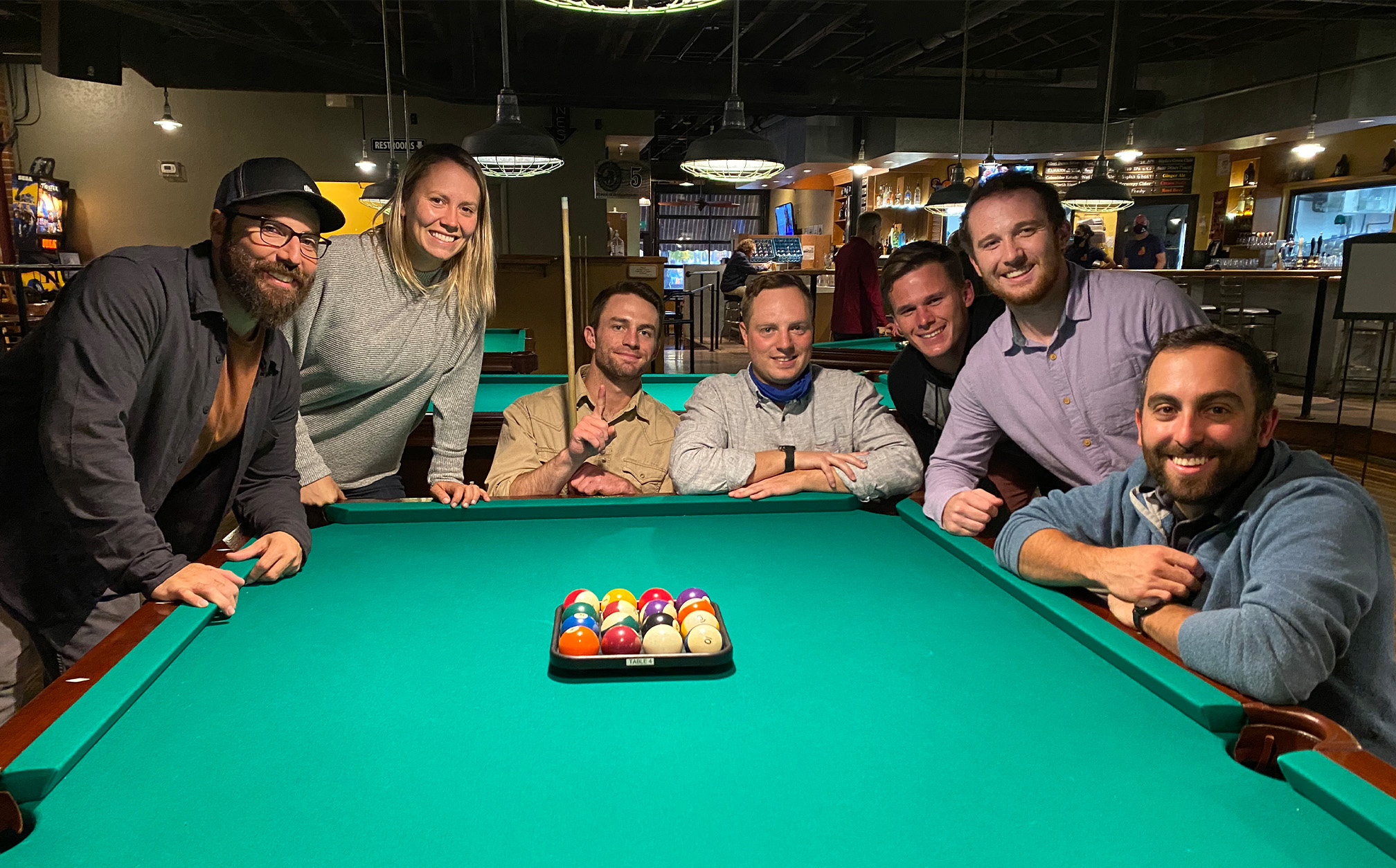 Group of employees playing pool